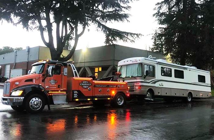 Motor home towing with medium-duty towing truck.